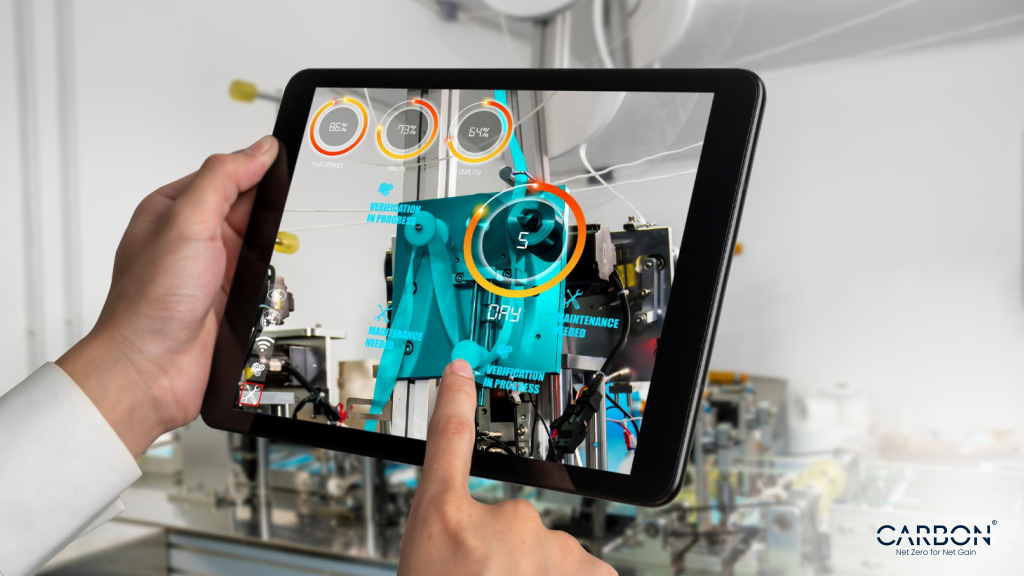 An engineer uses a tablet to scan factory equipment with AI-powered augmented reality, showing live metrics and maintenance alerts. This real-time visibility is central to predictive maintenance—catching inefficiencies before they escalate, reducing energy waste, cutting emissions, and preventing costly downtime.